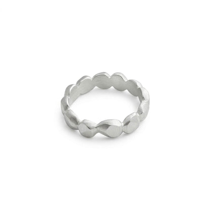 Silver ring with a textured band on a light gray background
