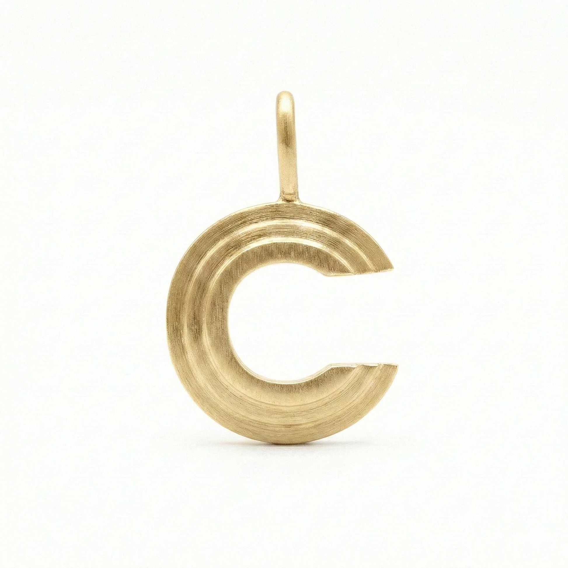 Gold letter 'C' pendant on a white background