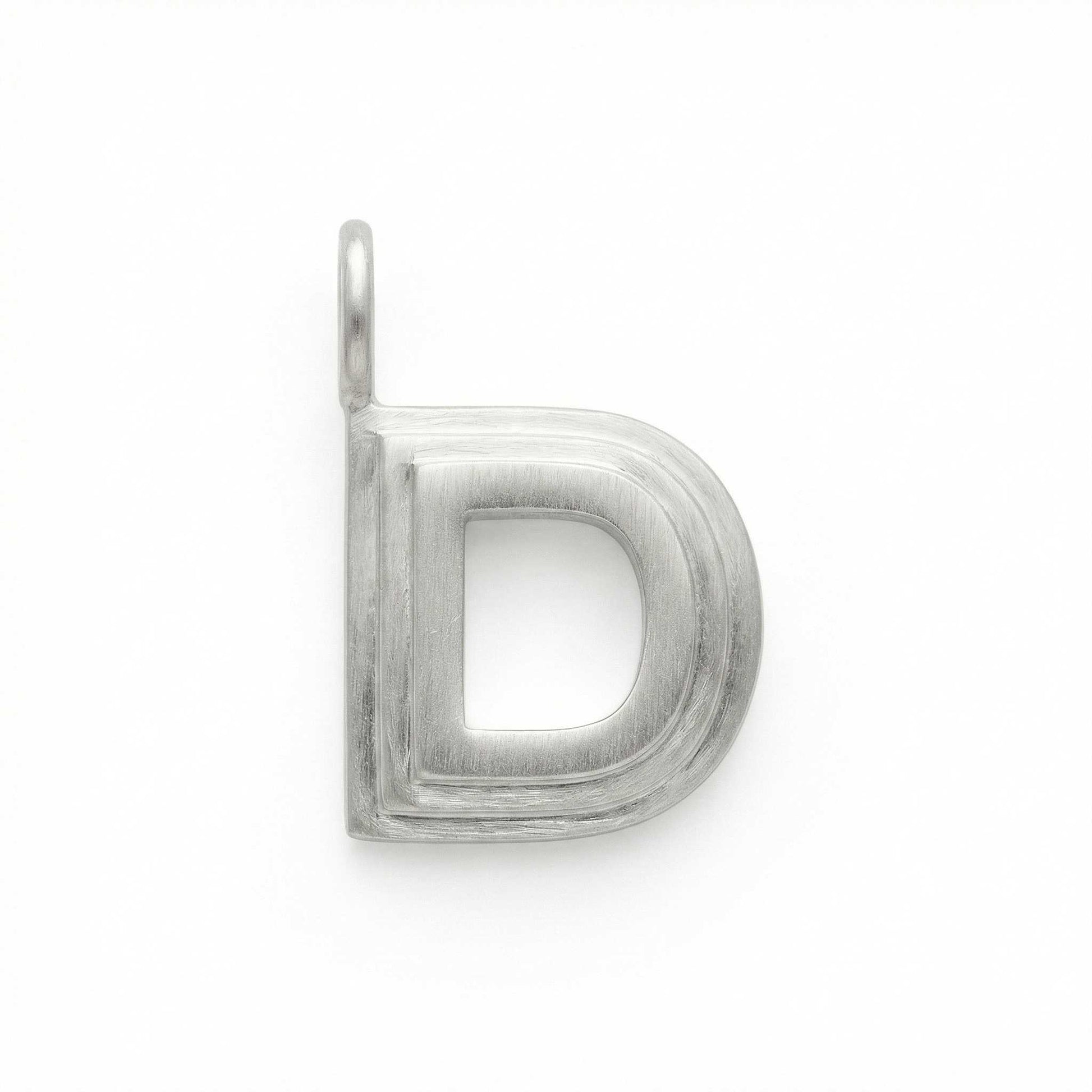 Silver letter 'D' pendant on a white background