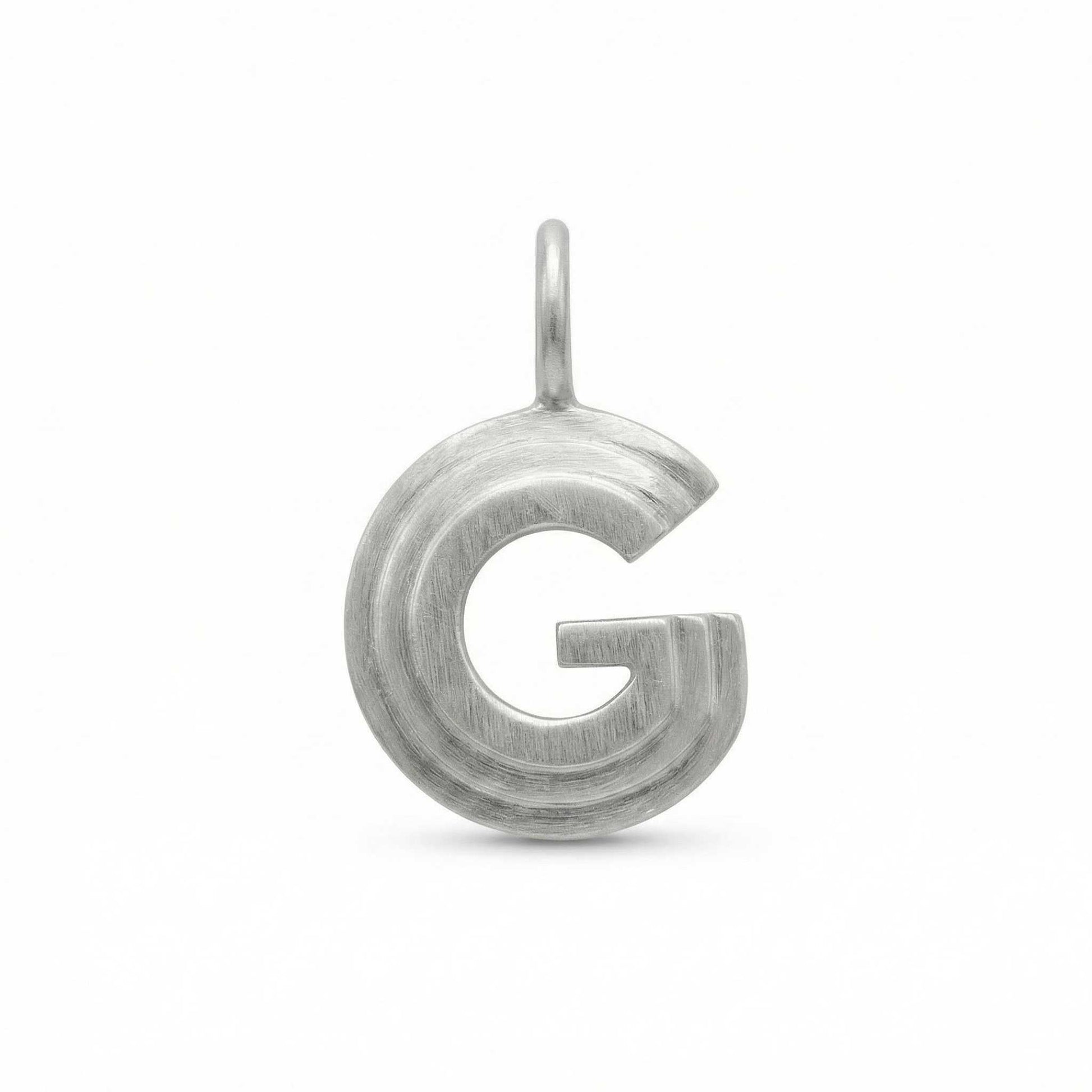 Silver letter 'G' pendant on a white background