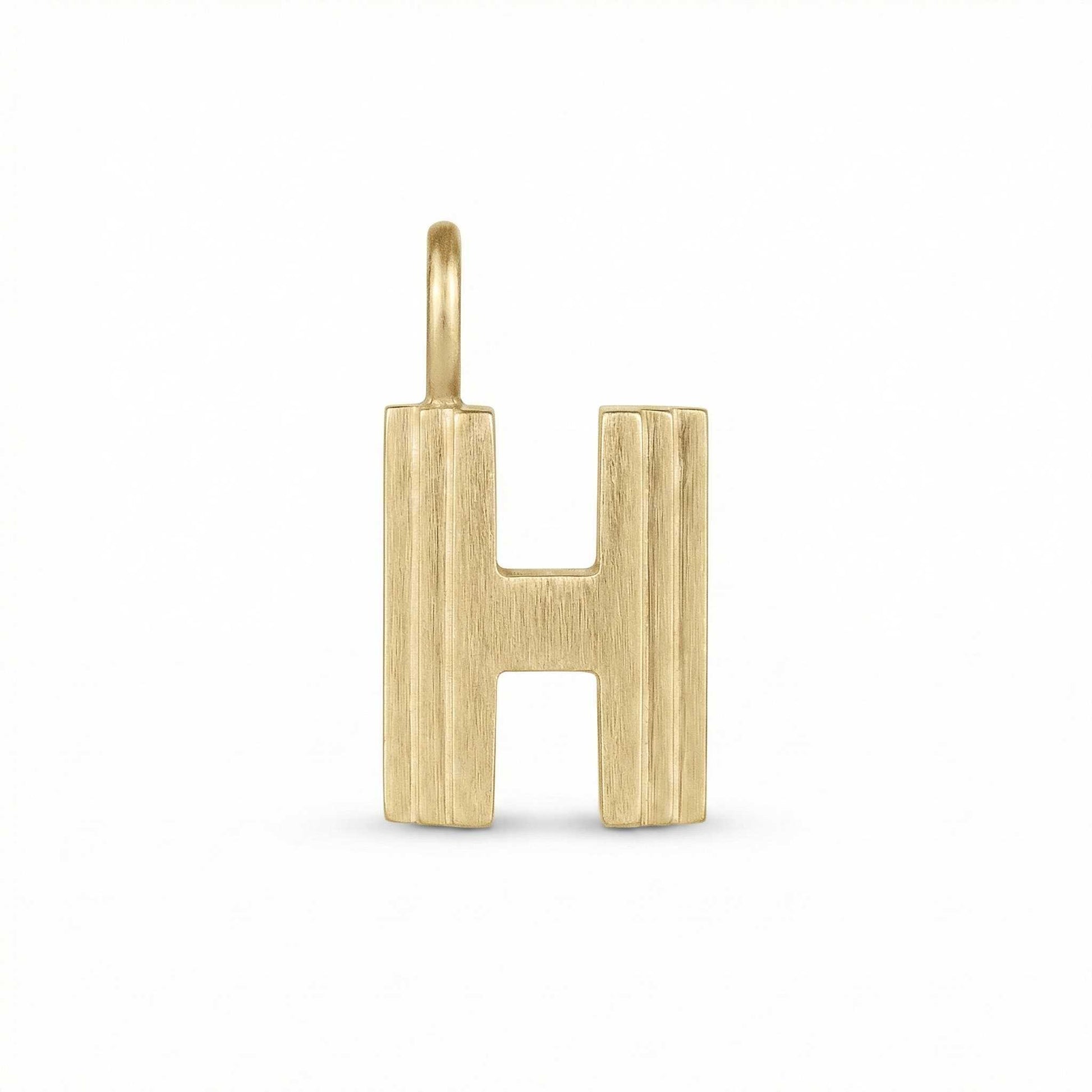 Gold letter 'H' pendant on a white background