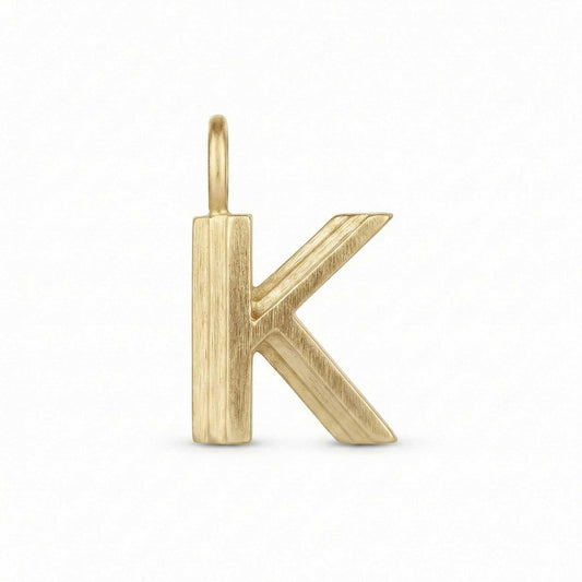 Gold letter 'K' pendant on a white background