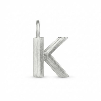 Silver letter 'K' pendant on a white background