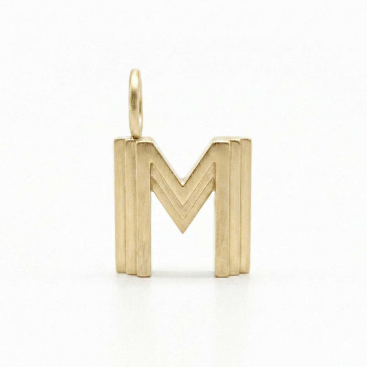 Gold letter 'M' pendant on a white background