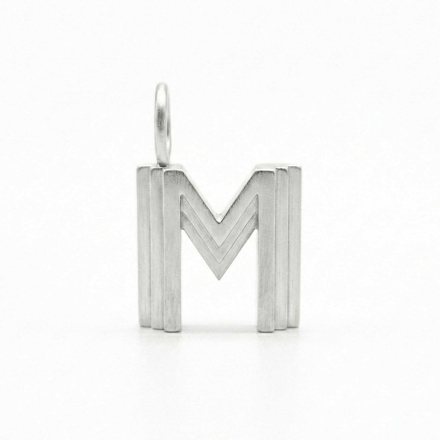 Silver letter 'M' pendant on a white background