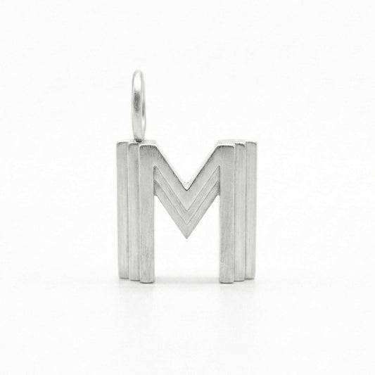 Silver letter 'M' pendant on a white background