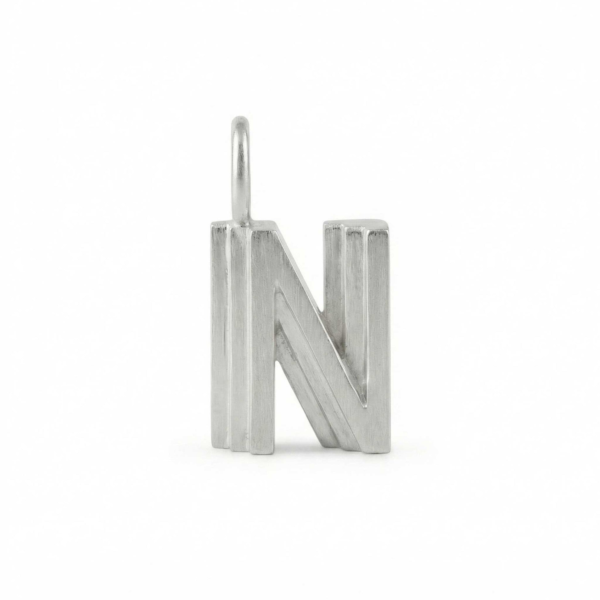 Silver letter 'N' pendant on a white background