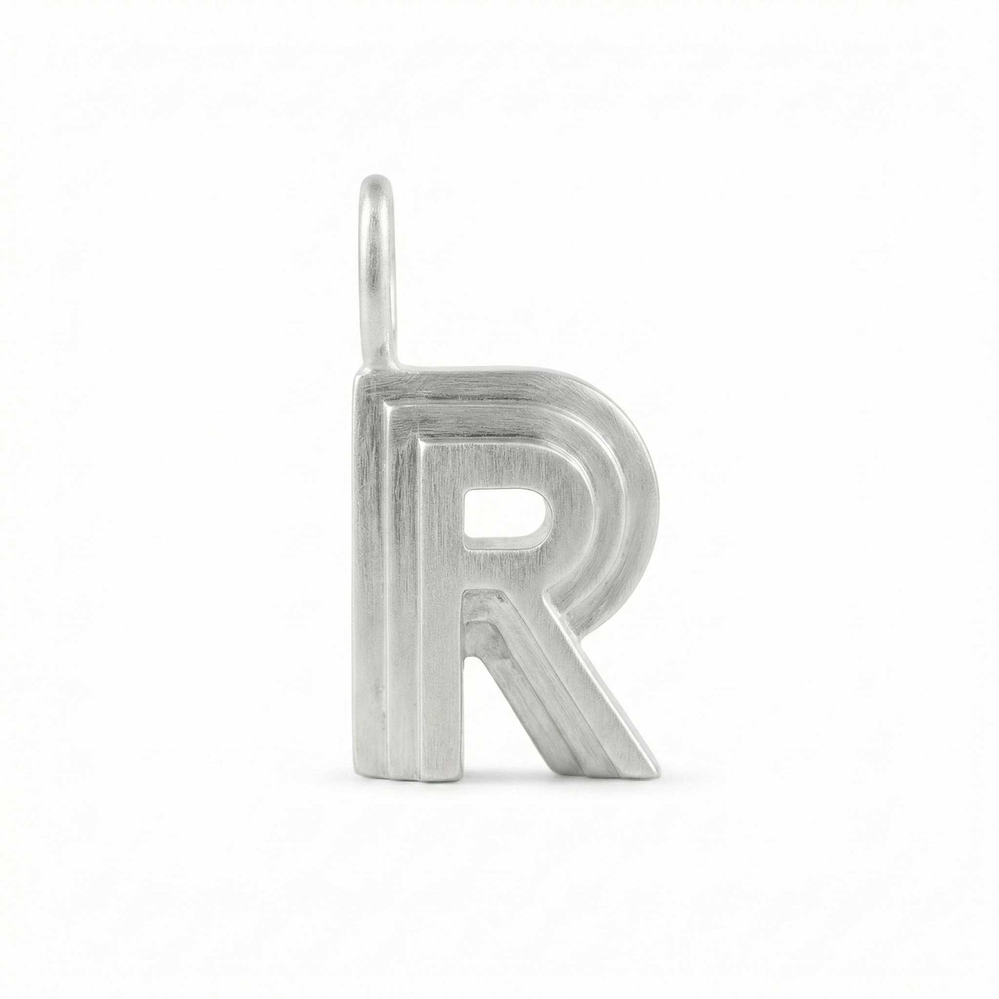 Silver letter 'R' pendant on a white background