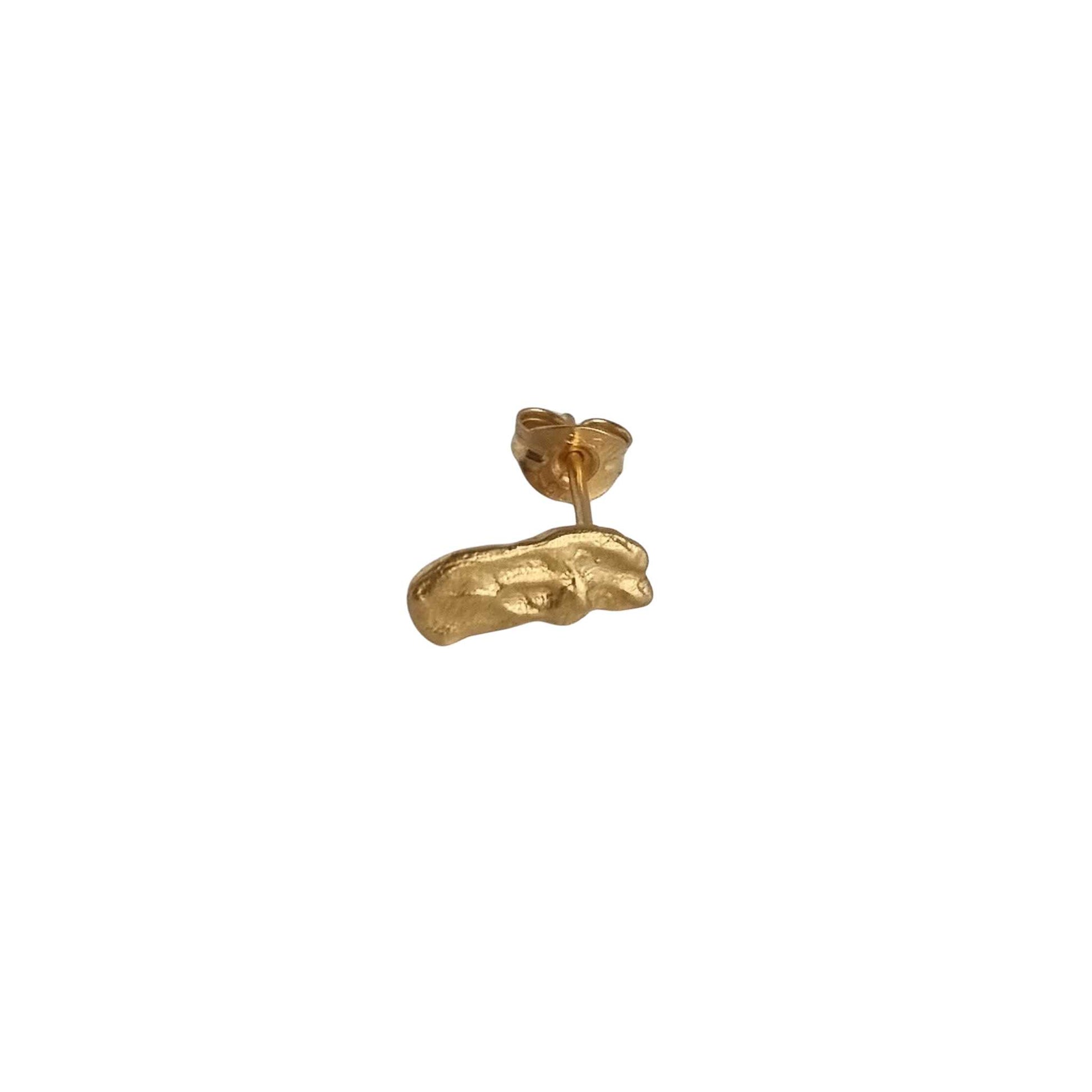 Gold earring on a white background